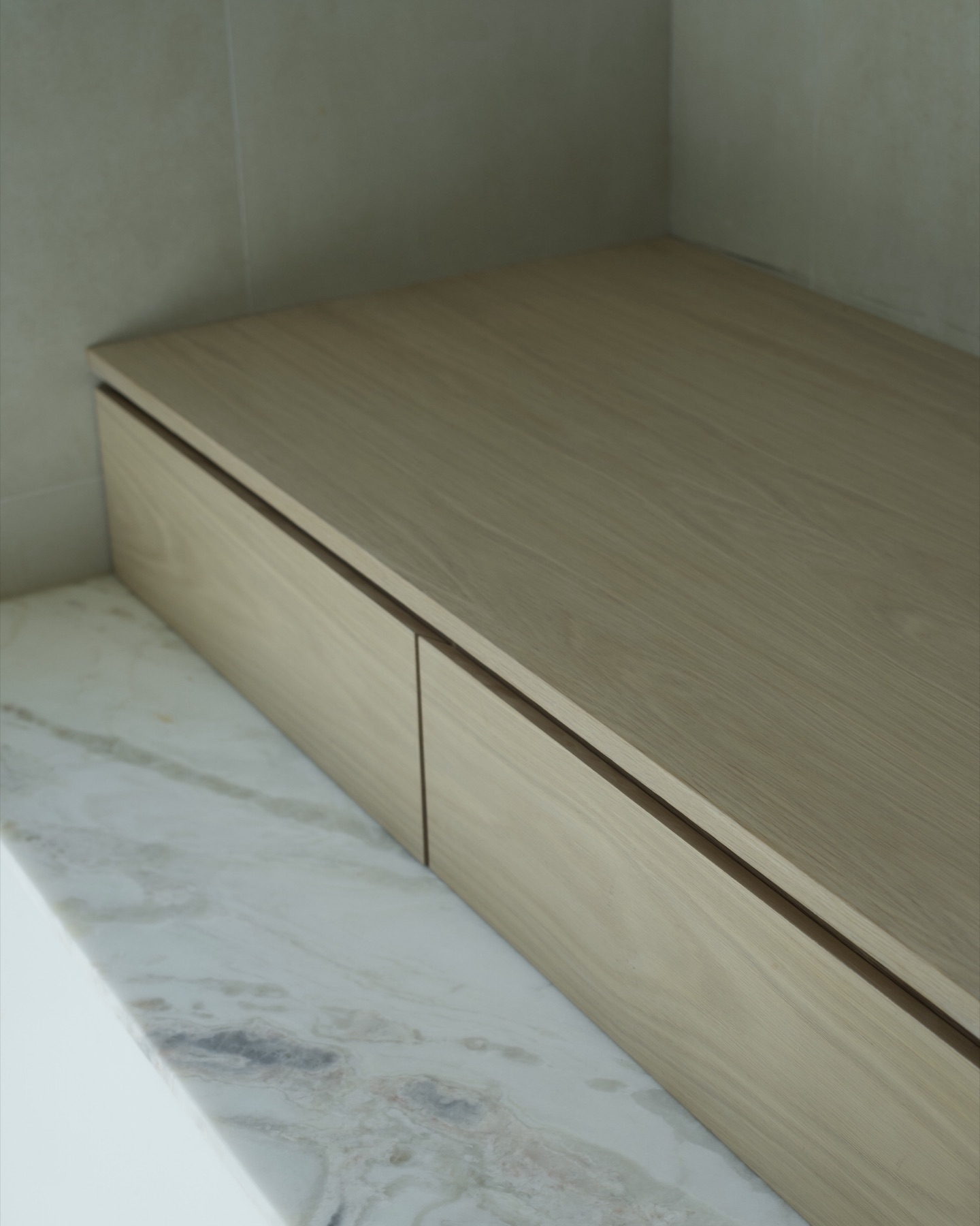 Custom white oak bench and drawers on marble